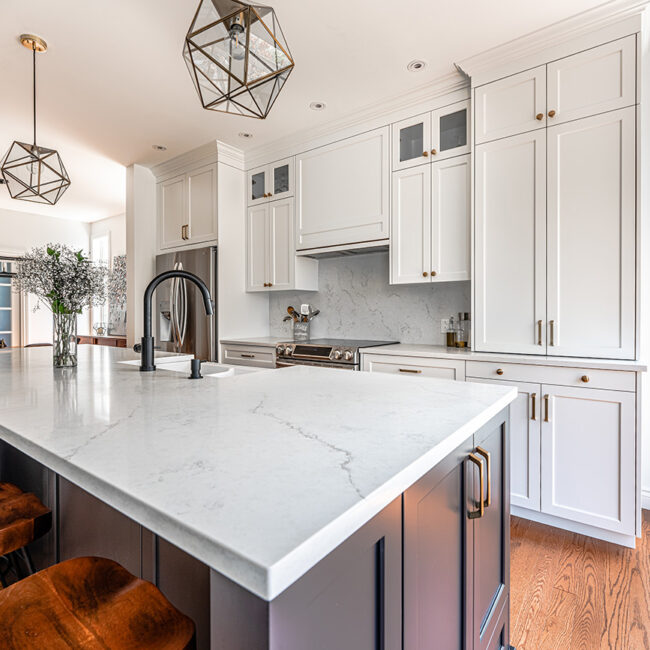 WIHM Design kitchen with white marble counter tops hard wood floors and white cabinets